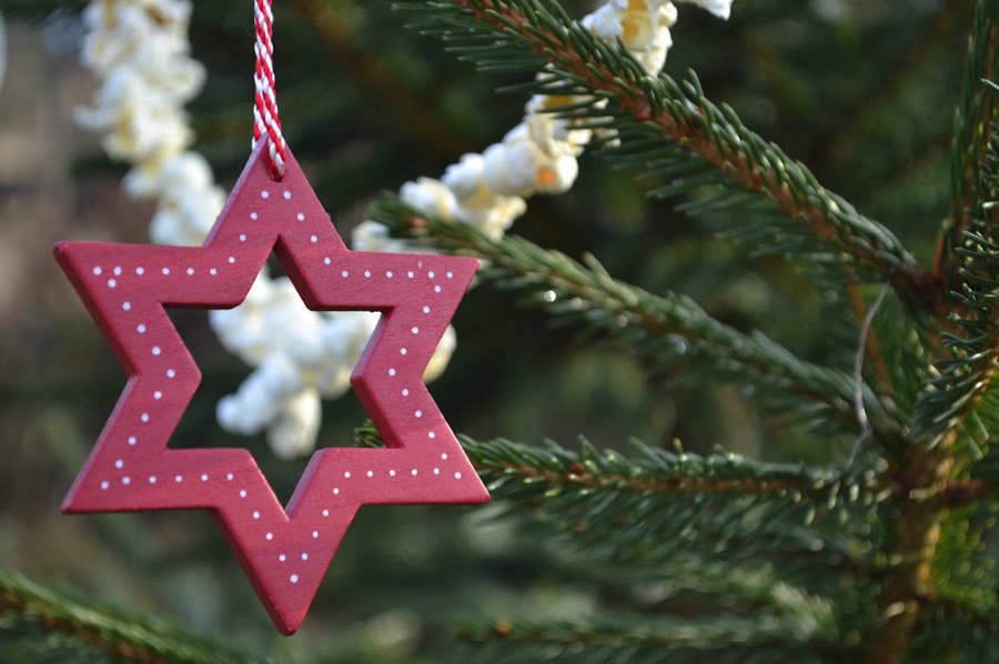 Wooden star on a real Christmas tree